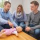 Jan-Niklas erläutert Julia und Daniel am Baby-Übungsmodell wichtige Handgriffe.